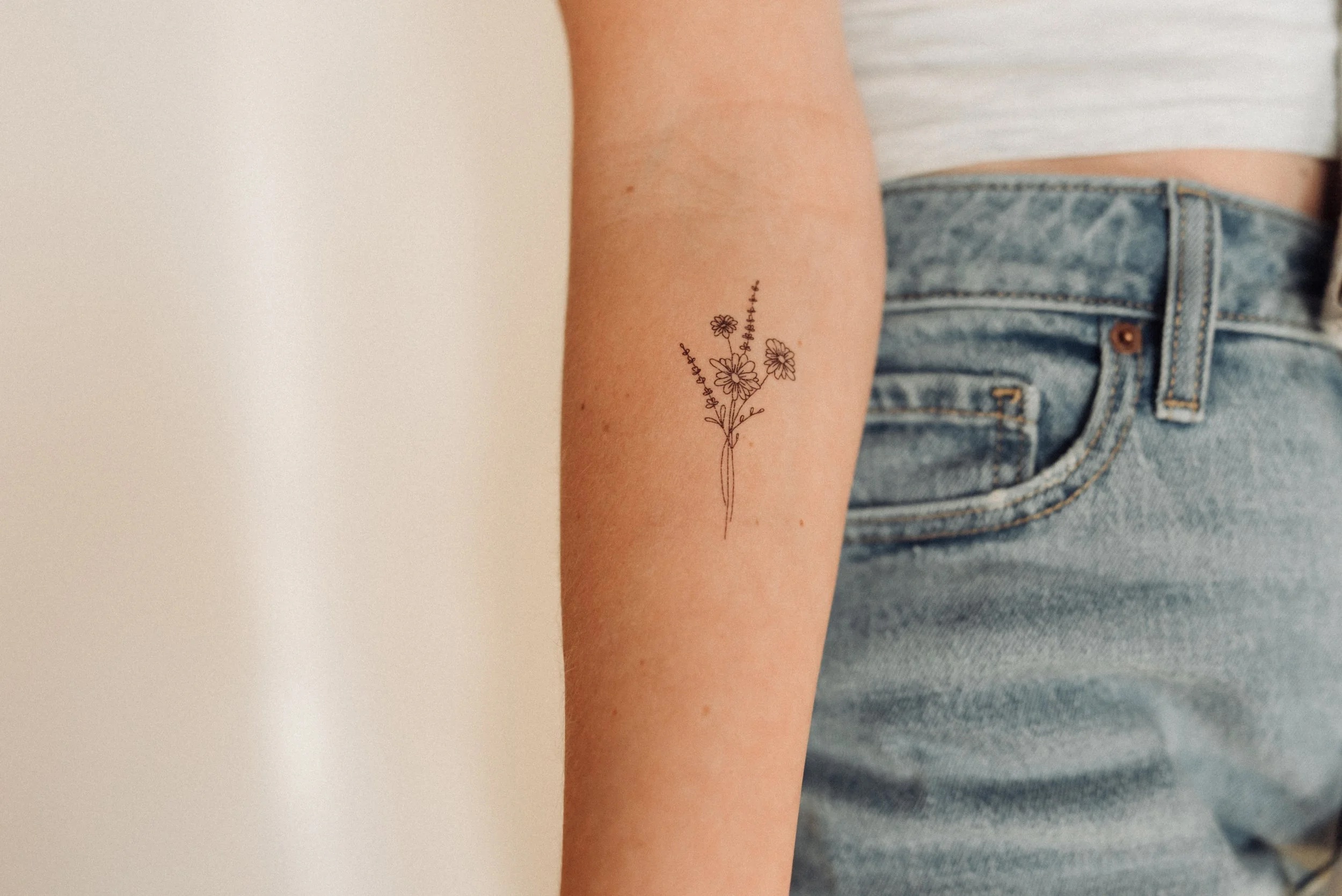 Fine line floral tattoo